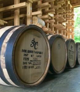 Jeptha Creed Bourbon barrel with people.