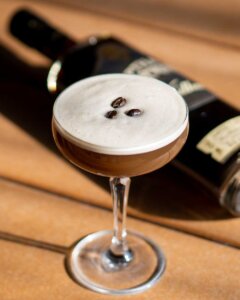 Jeptha Creed 'Espresso Martini' Cocktail with bottle of Jeptha Creed Coffee Flavored Vodka in the background.