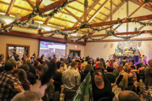 It appears to be a large gathering or party in a decorated hall