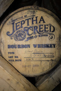 a wooden barrel of Jeptha Creed Bourbon Whiskey.