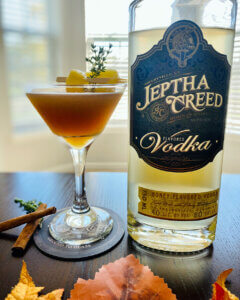 Three cocktails on a stone ledge.