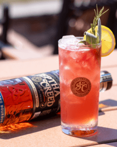 a bottle of Jeptha Creed Straight Bourbon and a cocktail made with it.