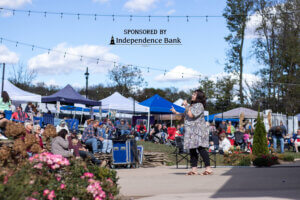 Woman speaking at outdoor event.